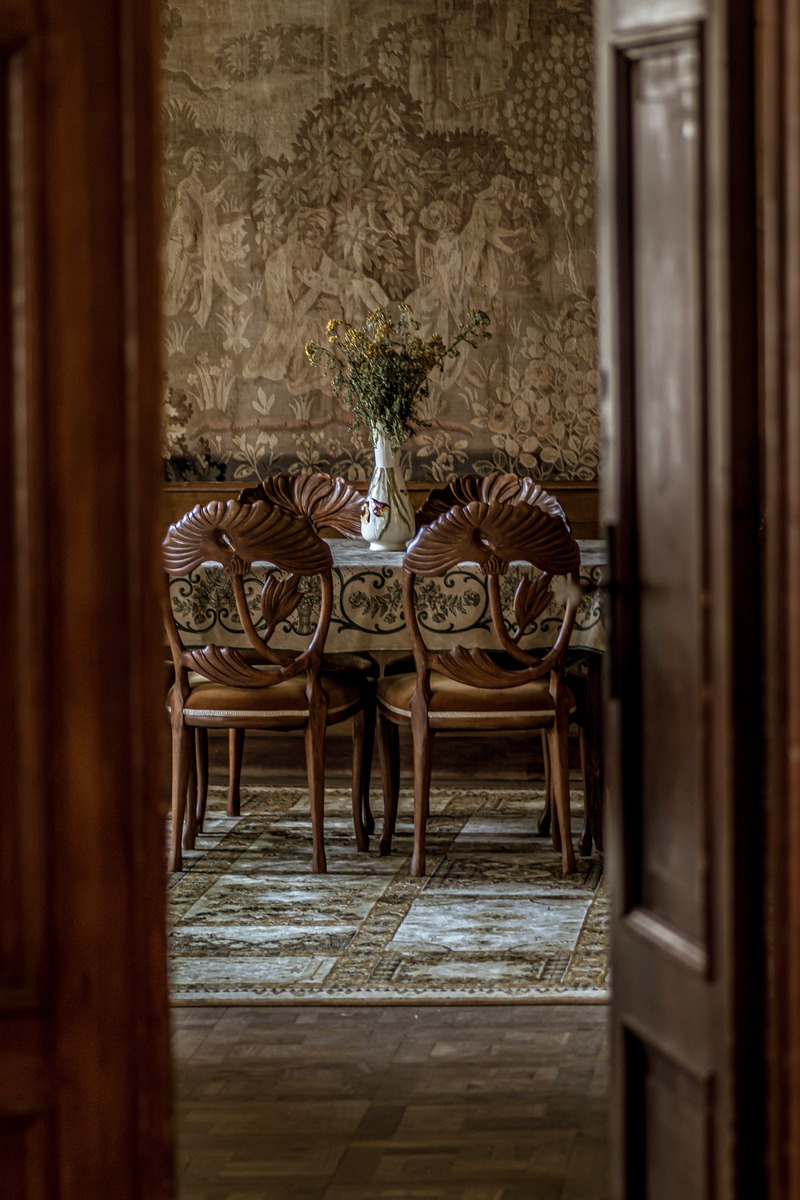 vertical-image-luxurious-dining-room-with-ornate-chairs-as-seen-through-open-door (1).jpg